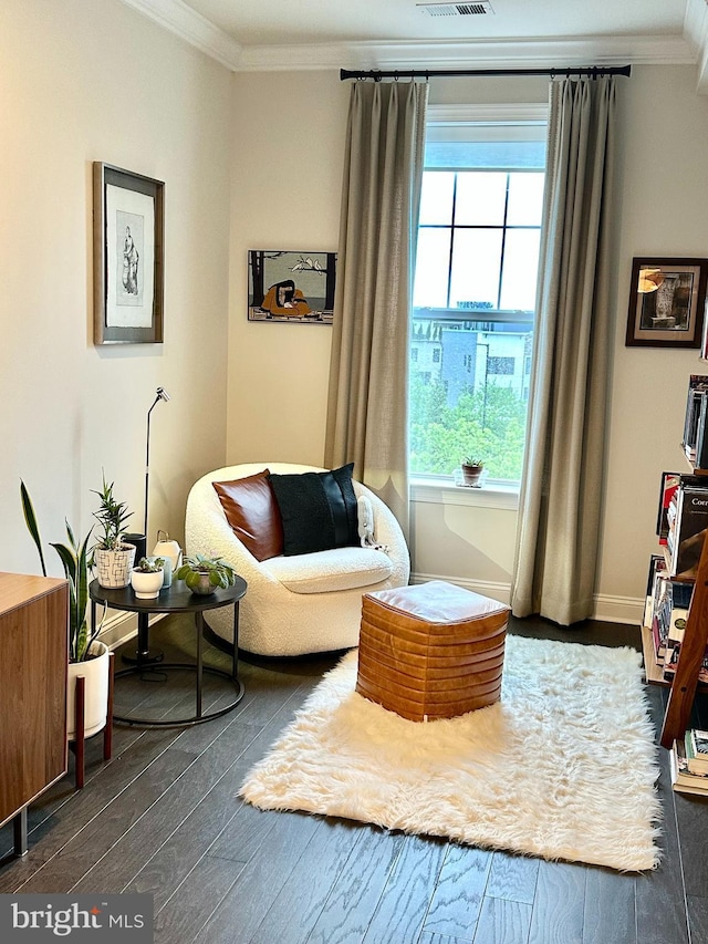 living area featuring ornamental molding, dark wood-style floors, and baseboards