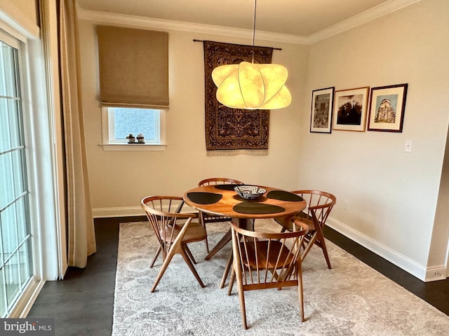 dining space featuring baseboards, crown molding, and dark wood-style floors
