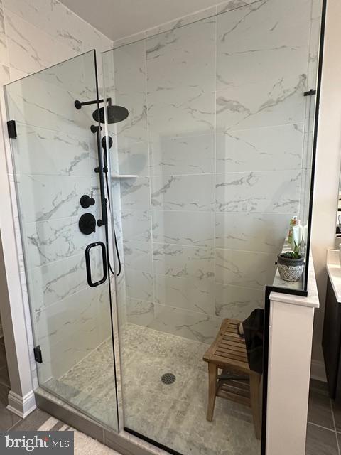 full bath featuring a stall shower and vanity