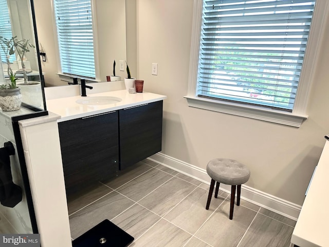 bathroom featuring baseboards and vanity