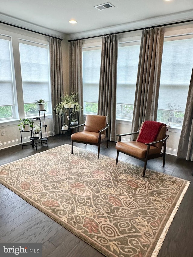 sitting room featuring baseboards, wood finished floors, and recessed lighting