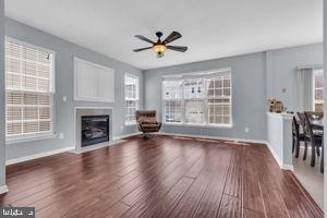 42783 Freedom St, Chantilly, VA 20152 - unfurnished living room featuring a ceiling fan, wood finished floors, and a fireplace