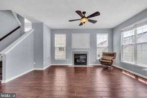 42783 Freedom St, Chantilly, VA 20152 - unfurnished living room with a glass covered fireplace, wood finished floors, and a ceiling fan
