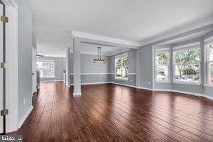 42783 Freedom St, Chantilly, VA 20152 - unfurnished living room featuring hardwood / wood-style floors, a chandelier, and crown molding