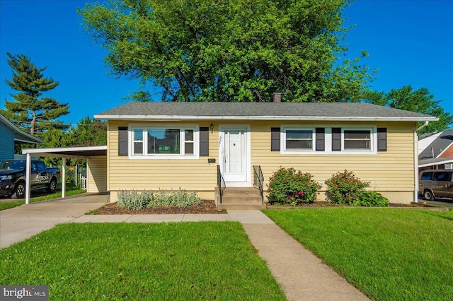 1426 W 11th St, Frederick, MD 21702 - bungalow-style home with a front lawn, a carport, concrete driveway, and entry steps