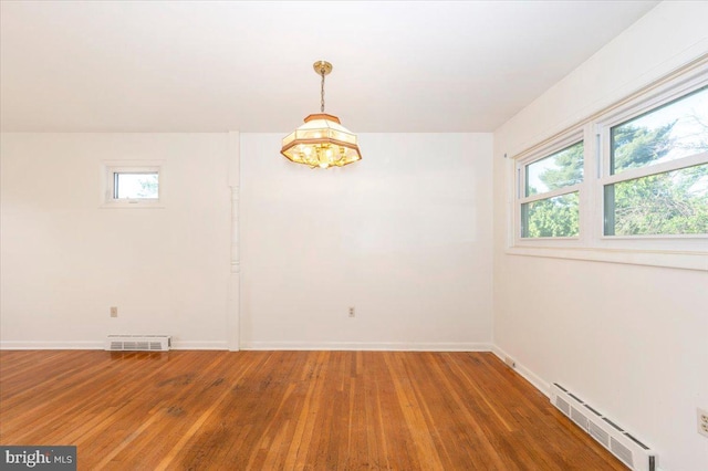 1426 W 11th St, Frederick, MD 21702 - empty room featuring hardwood / wood-style flooring, baseboard heating, a chandelier, and baseboards