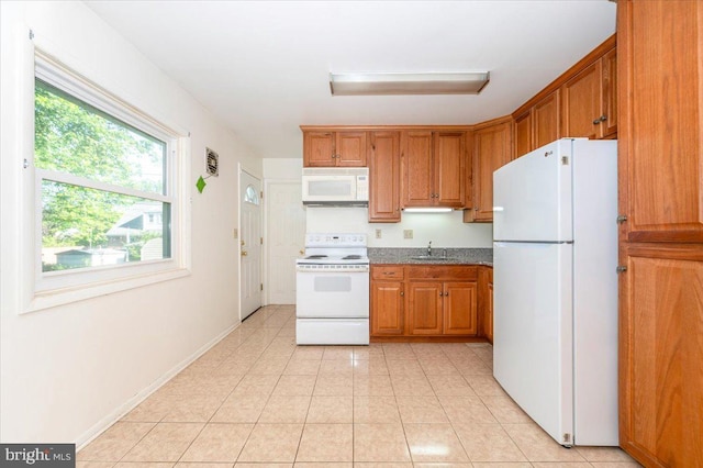 1426 W 11th St, Frederick, MD 21702 - kitchen featuring white appliances, a sink, brown cabinetry, and light tile patterned floors
