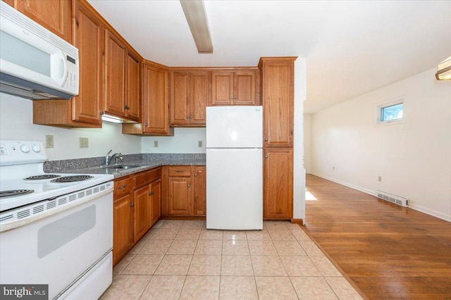 1426 W 11th St, Frederick, MD 21702 - kitchen featuring white appliances, a sink, brown cabinets, and light tile patterned floors