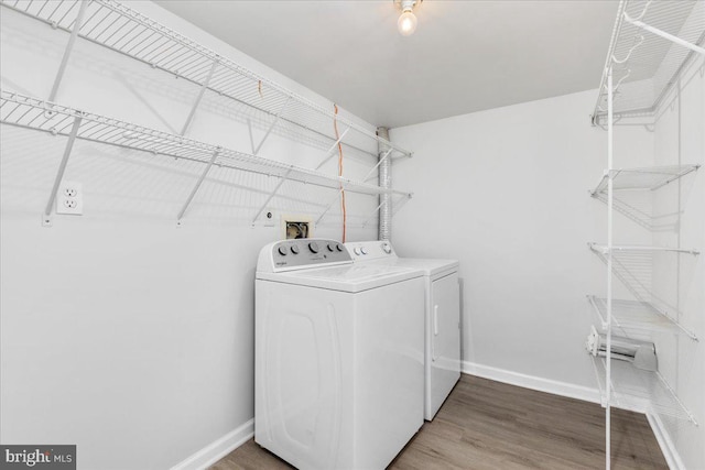 228 Doe Trl, Winchester, VA 22602 - washroom featuring separate washer and dryer, baseboards, and wood finished floors