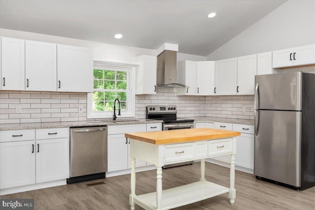 228 Doe Trl, Winchester, VA 22602 - kitchen featuring appliances with stainless steel finishes, wall chimney range hood, white cabinets, light wood-style floors, and backsplash