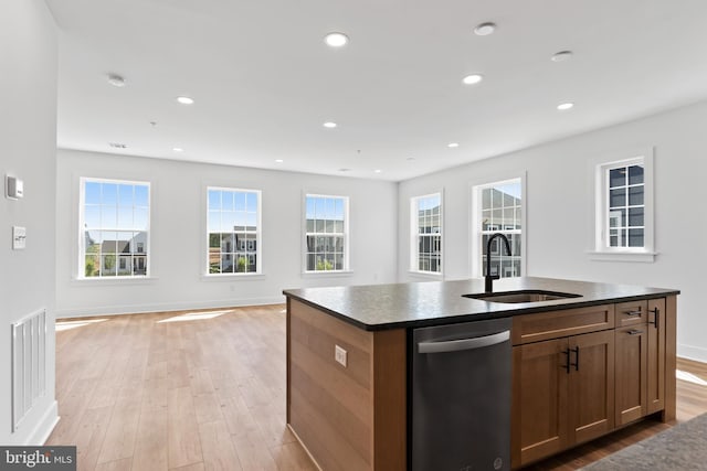 5 Graze Way, Carlisle, PA 17015 - kitchen featuring stainless steel dishwasher, dark countertops, a sink, open floor plan, and light wood finished floors