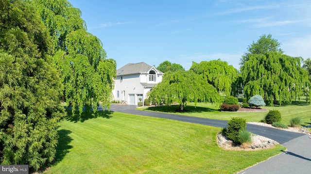 123 Nantucket Dr, Middletown, DE 19709 - view of home's community featuring asphalt driveway, a lawn, and an attached garage