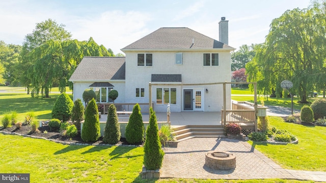 123 Nantucket Dr, Middletown, DE 19709 - rear view of property featuring an outdoor fire pit, a lawn, a chimney, and a wooden deck