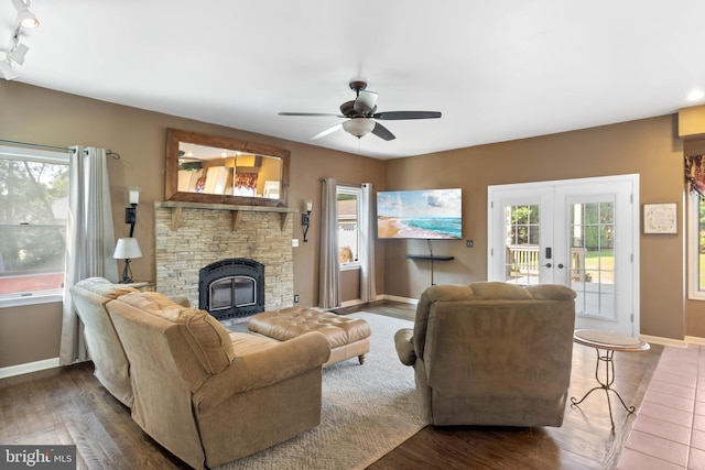 123 Nantucket Dr, Middletown, DE 19709 - living room with baseboards, a ceiling fan, wood finished floors, a stone fireplace, and french doors