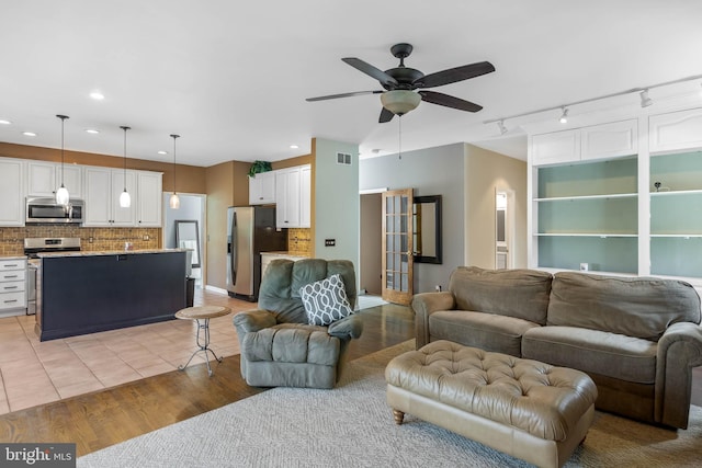 123 Nantucket Dr, Middletown, DE 19709 - living room with rail lighting, ceiling fan, recessed lighting, and light wood finished floors