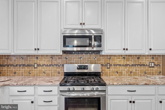 123 Nantucket Dr, Middletown, DE 19709 - kitchen with appliances with stainless steel finishes, white cabinetry, and backsplash