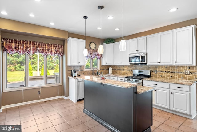 123 Nantucket Dr, Middletown, DE 19709 - kitchen featuring appliances with stainless steel finishes, a sink, light tile patterned floors, tasteful backsplash, and white cabinetry
