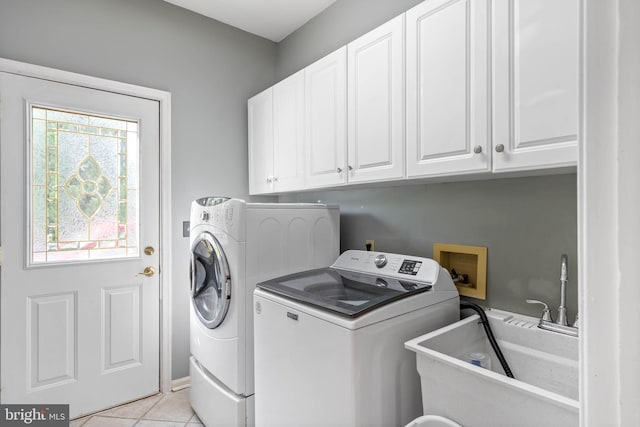 123 Nantucket Dr, Middletown, DE 19709 - clothes washing area featuring independent washer and dryer, cabinet space, and light tile patterned flooring