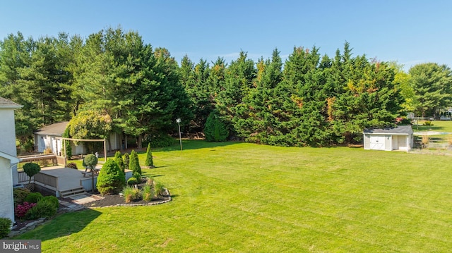 123 Nantucket Dr, Middletown, DE 19709 - view of green lawn with an outbuilding, a storage unit, and a wooden deck
