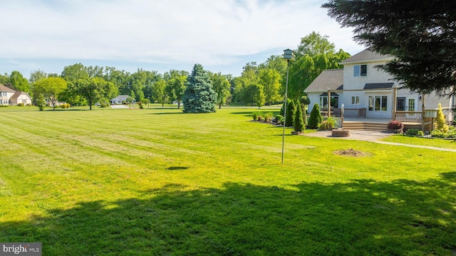 123 Nantucket Dr, Middletown, DE 19709 - view of green lawn with a wooden deck and an outdoor fire pit