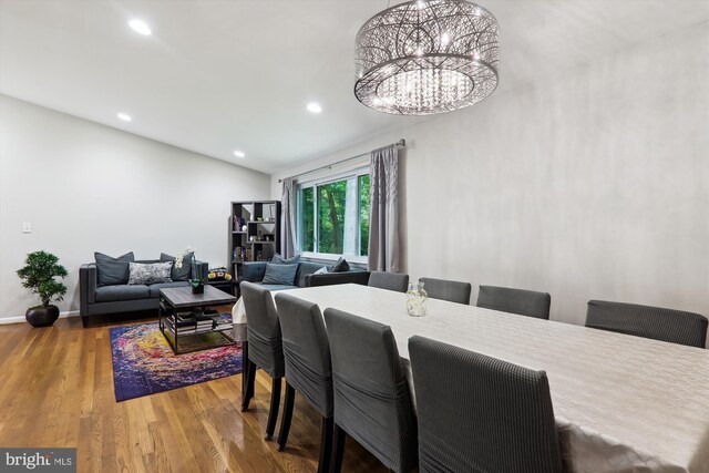 dining area with recessed lighting, wood finished floors, a chandelier, baseboards, and lofted ceiling