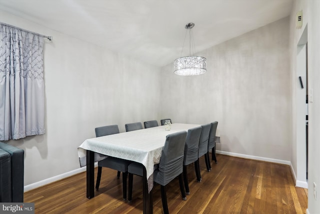 dining room featuring wood finished floors and baseboards