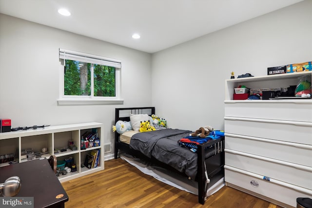 bedroom featuring wood finished floors and recessed lighting