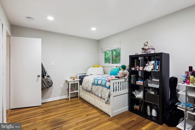 bedroom with wood finished floors, recessed lighting, and baseboards