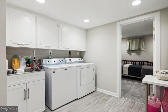 laundry room with washer and dryer, cabinet space, light wood-style floors, recessed lighting, and baseboards