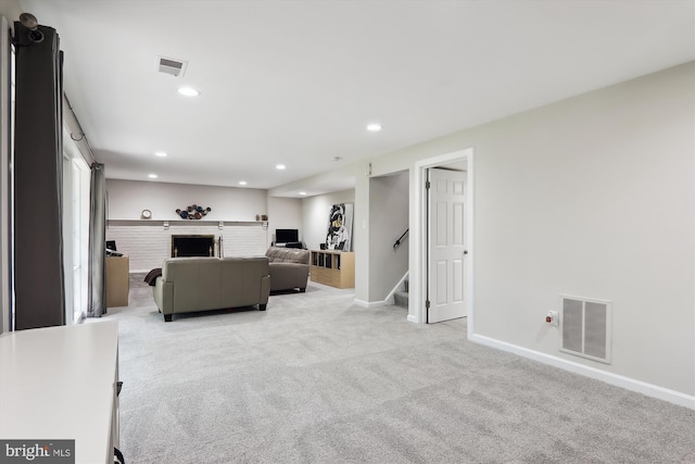 living area with light colored carpet, baseboards, recessed lighting, and stairs