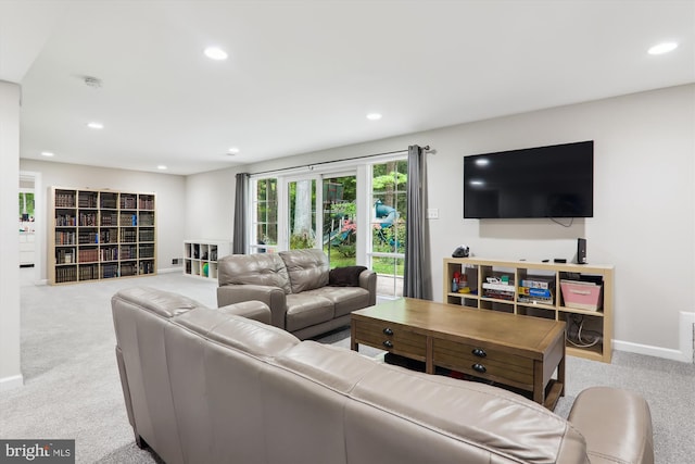 carpeted living area featuring recessed lighting and baseboards