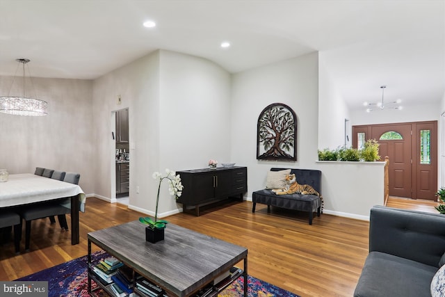 living area with a chandelier, wood finished floors, recessed lighting, and baseboards