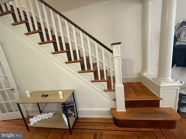 stairway featuring baseboards and wood finished floors