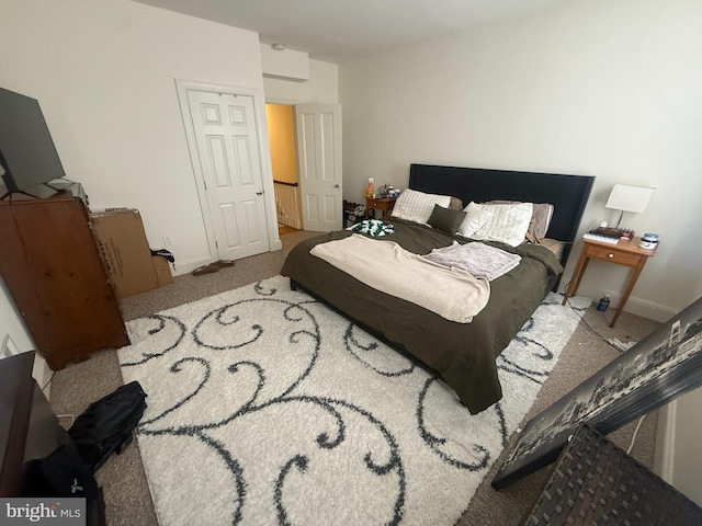 bedroom with carpet and baseboards