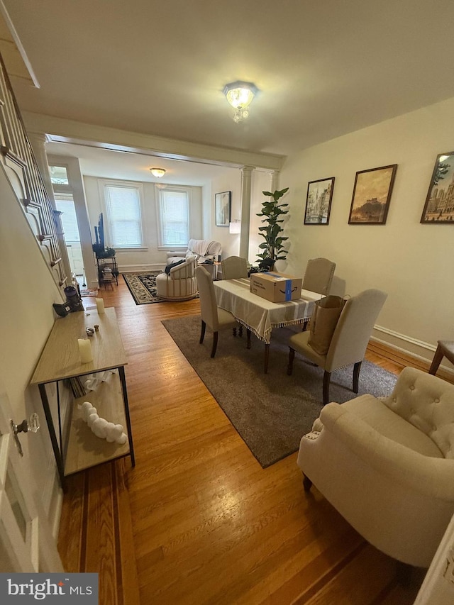 dining room with wood finished floors, stairs, and baseboards