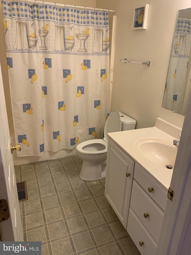 1170 Hisey Ave, Woodstock, VA 22664 - full bathroom with toilet, vanity, tile patterned floors, and shower / bath combo with shower curtain