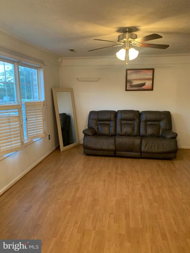 1170 Hisey Ave, Woodstock, VA 22664 - living room featuring wood finished floors, ornamental molding, a ceiling fan, and baseboards