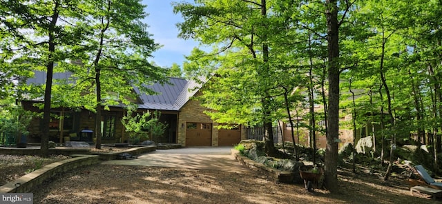227 Haines Dr, Capon Bridge, WV 26711 - view of property exterior with concrete driveway, a standing seam roof, a garage, and stone siding