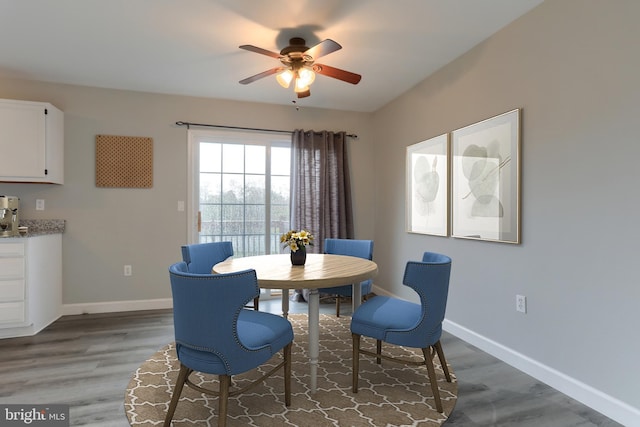 dining area featuring ceiling fan, wood finished floors, and baseboards
