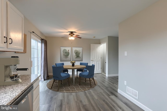 dining area featuring a ceiling fan, wood finished floors, and baseboards