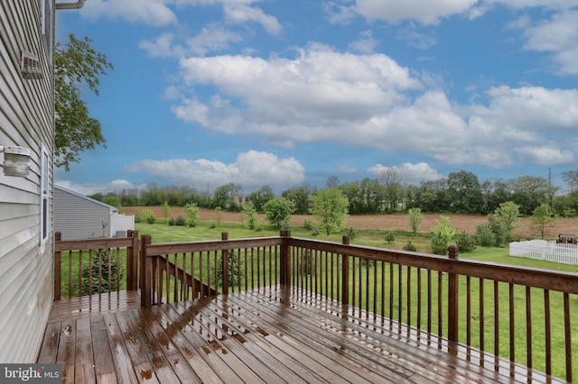 wooden deck with a lawn and a view of rural / pastoral area