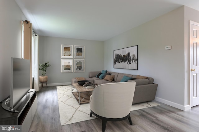 living area with wood finished floors and baseboards