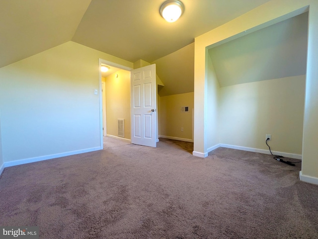 additional living space with vaulted ceiling, carpet flooring, and baseboards