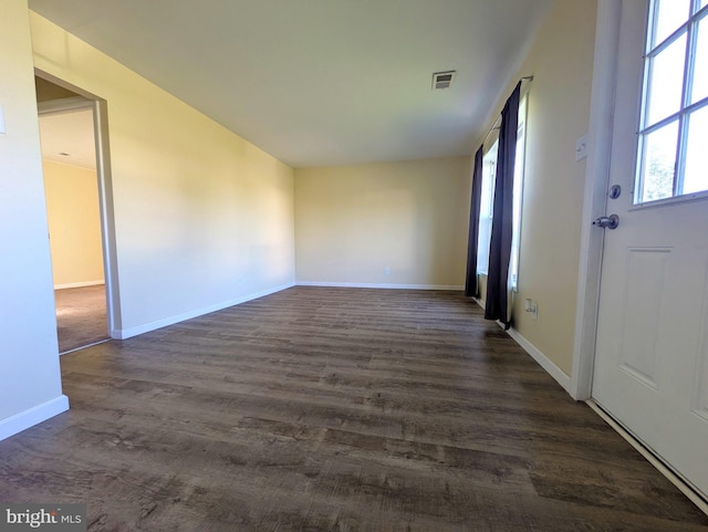 entrance foyer with dark wood-style flooring and baseboards