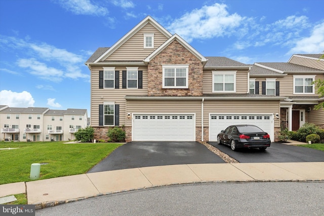 view of property featuring stone siding, driveway, a garage, and a front lawn