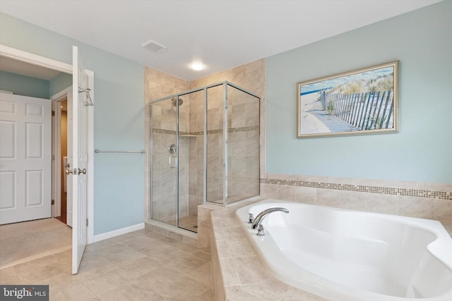 full bathroom featuring a stall shower, a garden tub, and tile patterned flooring