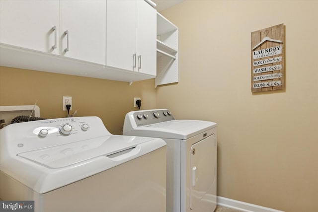 washroom featuring independent washer and dryer and cabinet space