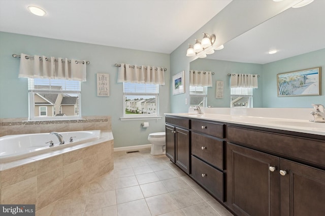 full bathroom with plenty of natural light, toilet, a bath, and tile patterned floors