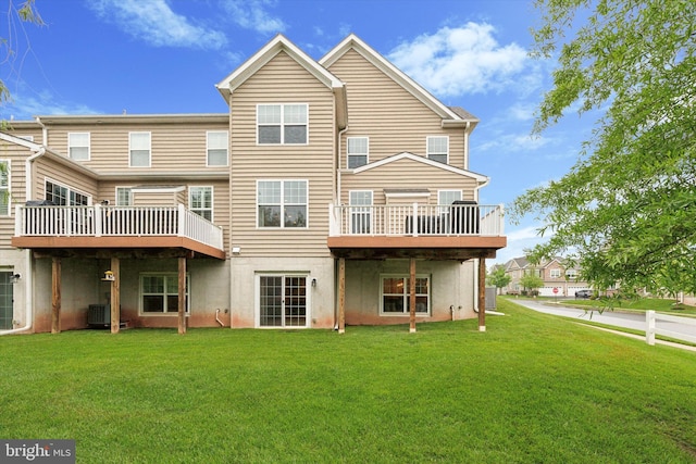 rear view of property featuring a yard, cooling unit, and a deck