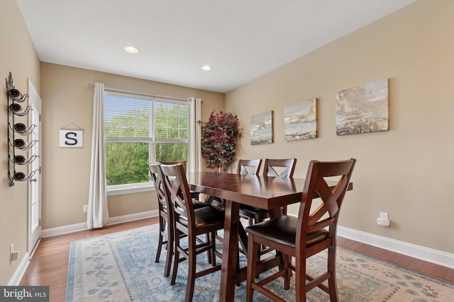 dining room featuring light wood finished floors, baseboards, and recessed lighting